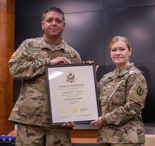Command Sgt. Maj. Mary Dixon, of Chapin, Illinois, is presented a certificate of retirement by Lt. Col. Wyatt Bickett, officer-in-charge, 129th Regiment (Regional Training Institute), during a retirement ceremony Sept. 18 at the Illinois Military Academy on Camp Lincoln, Springfield, Illinois. Dixon will retire Sept. 30 after more than 28 years of service in the Illinois Army National Guard