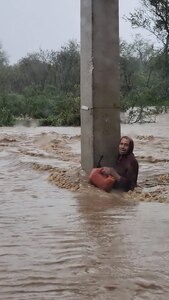 A man clings to a concrete beam in Ponce, Puerto Rico, during flooding caused by Hurricane Fiona Sept. 17-18, 2022. He was rescued by members of the 125th Military Police Battalion, Puerto Rico National Guard.