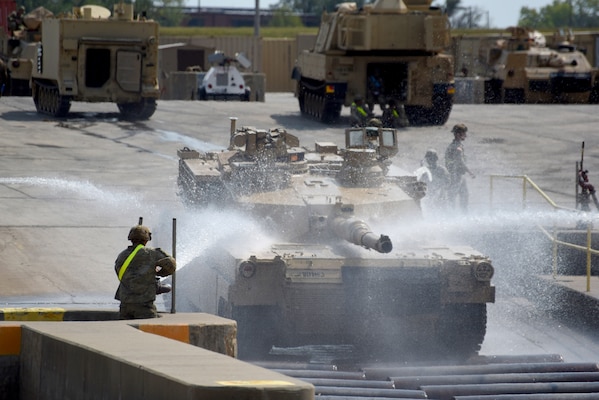 Soldiers wash a tank at a Fort Riley wash rack.