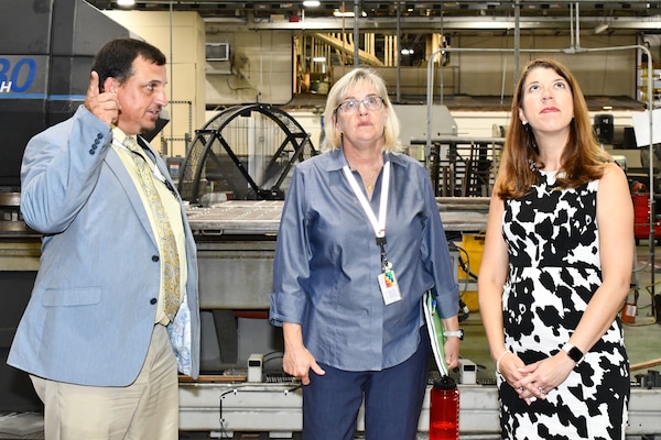 Group looks at ceiling of aircraft hangar