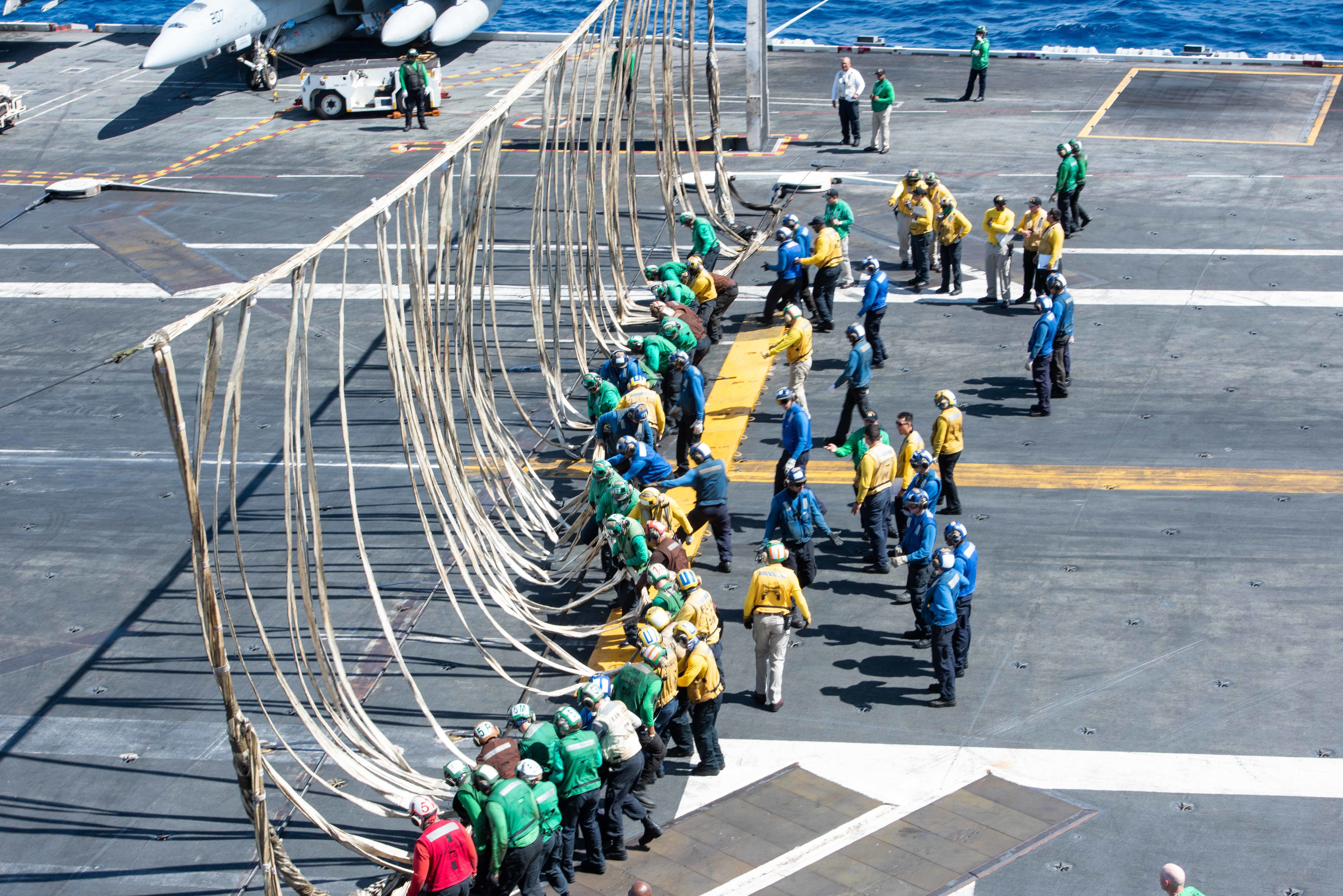 Sailors raise a barricade during a flight deck drill the U.S. Navy's only forward-deployed aircraft carrier, USS Ronald Reagan (CVN 76), in the Pacific Ocean.