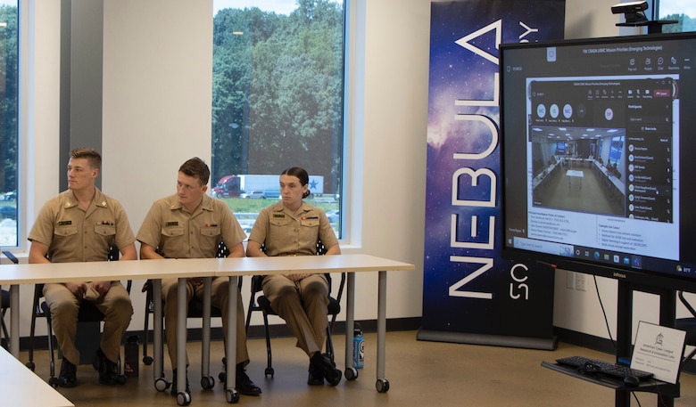 Midshipmen from the U.S. Naval Academy attend a briefing at X Corp Solutions, a cyber-technology firm headquartered at the Quantico Corporate Center, Aug. 12, 2022, in Stafford, Virginia, as part of the Program Executive Officer Land Systems internship program. Launched in 2013, the PEO Land Systems internship program provides an avenue for midshipmen to gain practical skills and hands-on experience in military acquisitions.  (U.S. Marine Corps photo by Mark Hoots