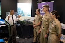 Marine Corps Systems Command Chief Technology Officer, Luis Velazquez, briefs U.S. Naval Academy midshipmen participating in the Program Executive Officer Land Systems internship program at X Corps Solutions in Stafford, Virginia, Aug. 12, 2022. Launched in 2013, the PEO Land Systems internship program provides an avenue for midshipmen to gain practical skills and hands-on experience in military acquisitions.  (U.S. Marine Corps photo by Mark Hoots)