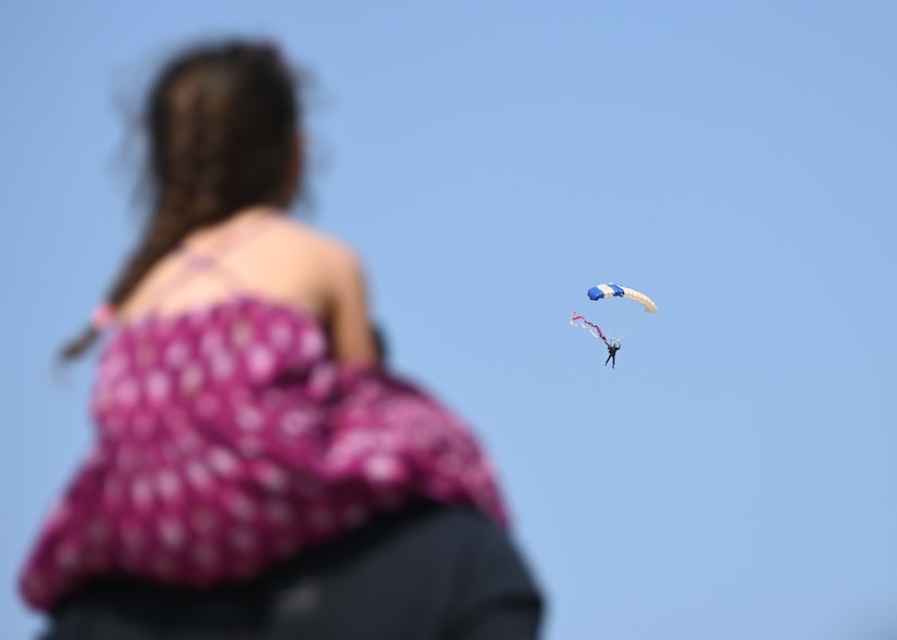 Attendees watch the U.S. Air Force Academy Wings of Blue parachute during the Joint Base Andrews 2022 Air & Space Expo at JBA, Md., Sept. 17, 2022.