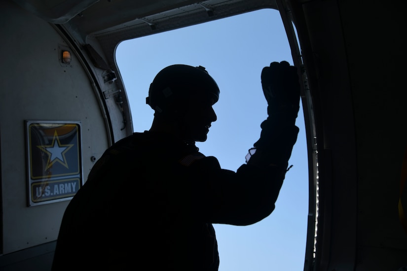 A parachutist with the U.S. Army Parachute Team, the Golden Knights, signals a “hold” sign before a jump during the Joint Base Andrews 2022 Air & Space Expo at JBA, Md., Sept. 16, 2022.