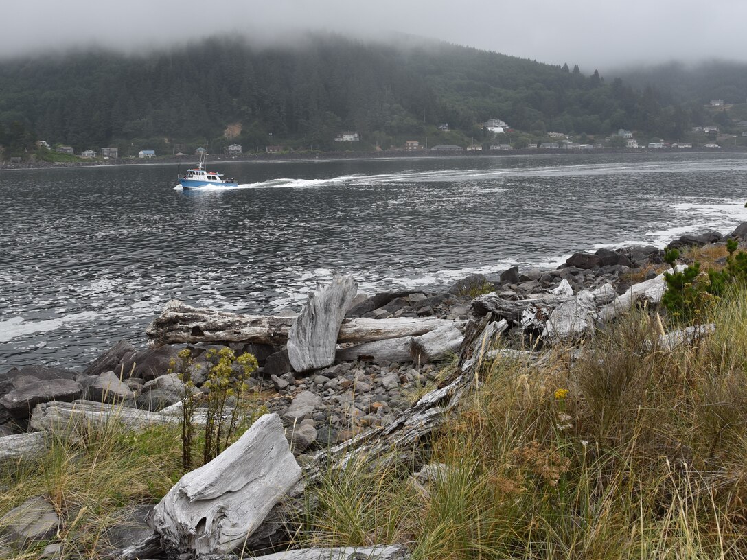 A commercial fishing boat passes between Tillamook Bay's two jetties on it's way out to sea. Portland District, U.S. Army Corps of Engineers completed an environmental assessment of planned repairs to the south jetty and has determined that the proposed action will not result in significant impacts to the human environment.
