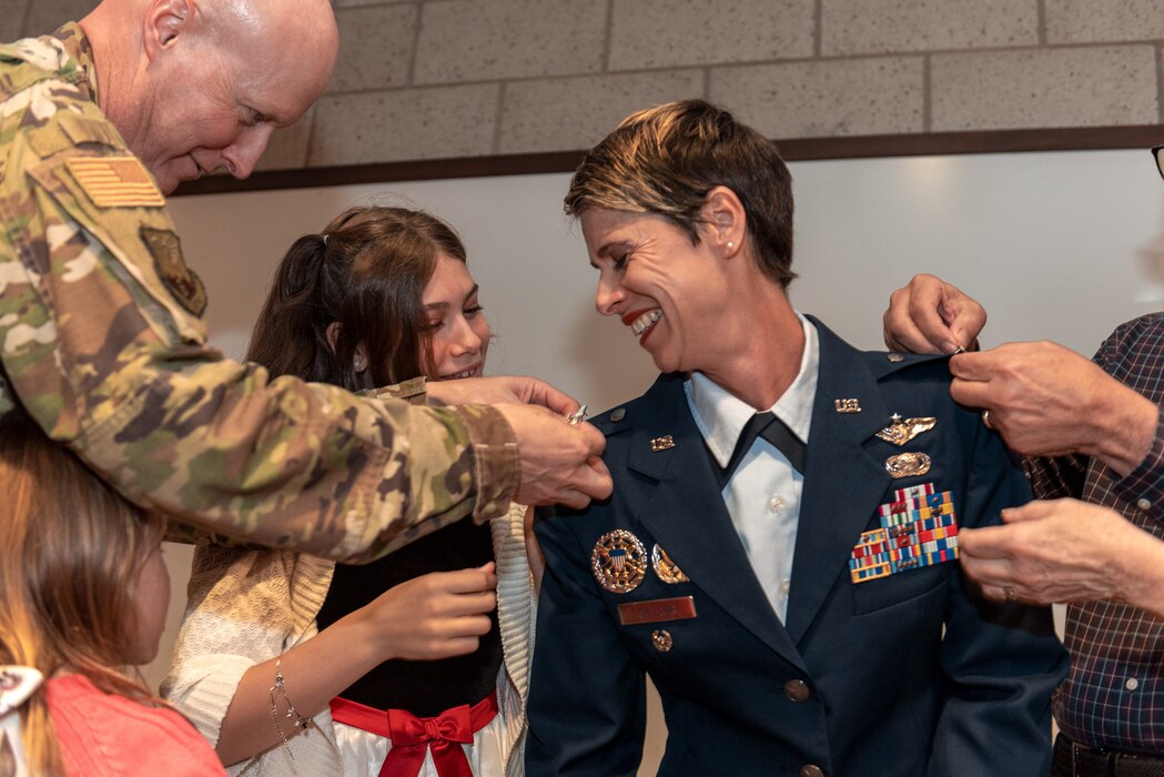 Airman receiving new rank from family.