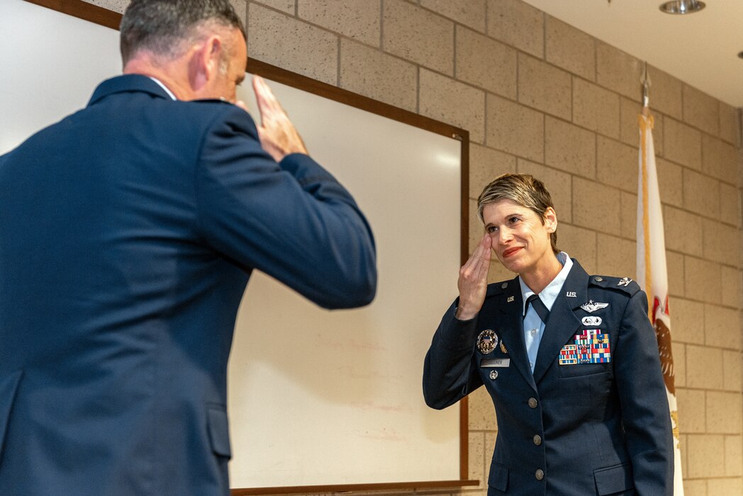Airmen saluting.