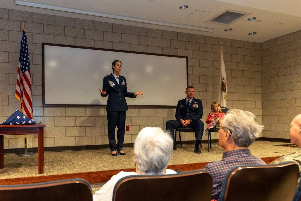Airman speaking on stage.