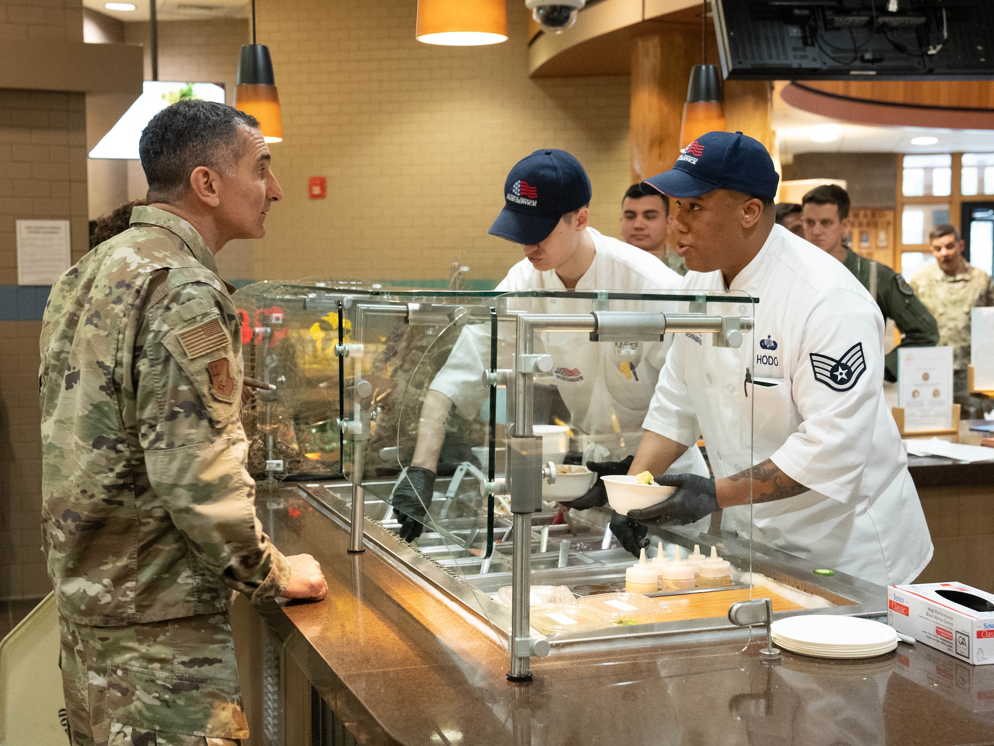 A photo of a cook serving food.
