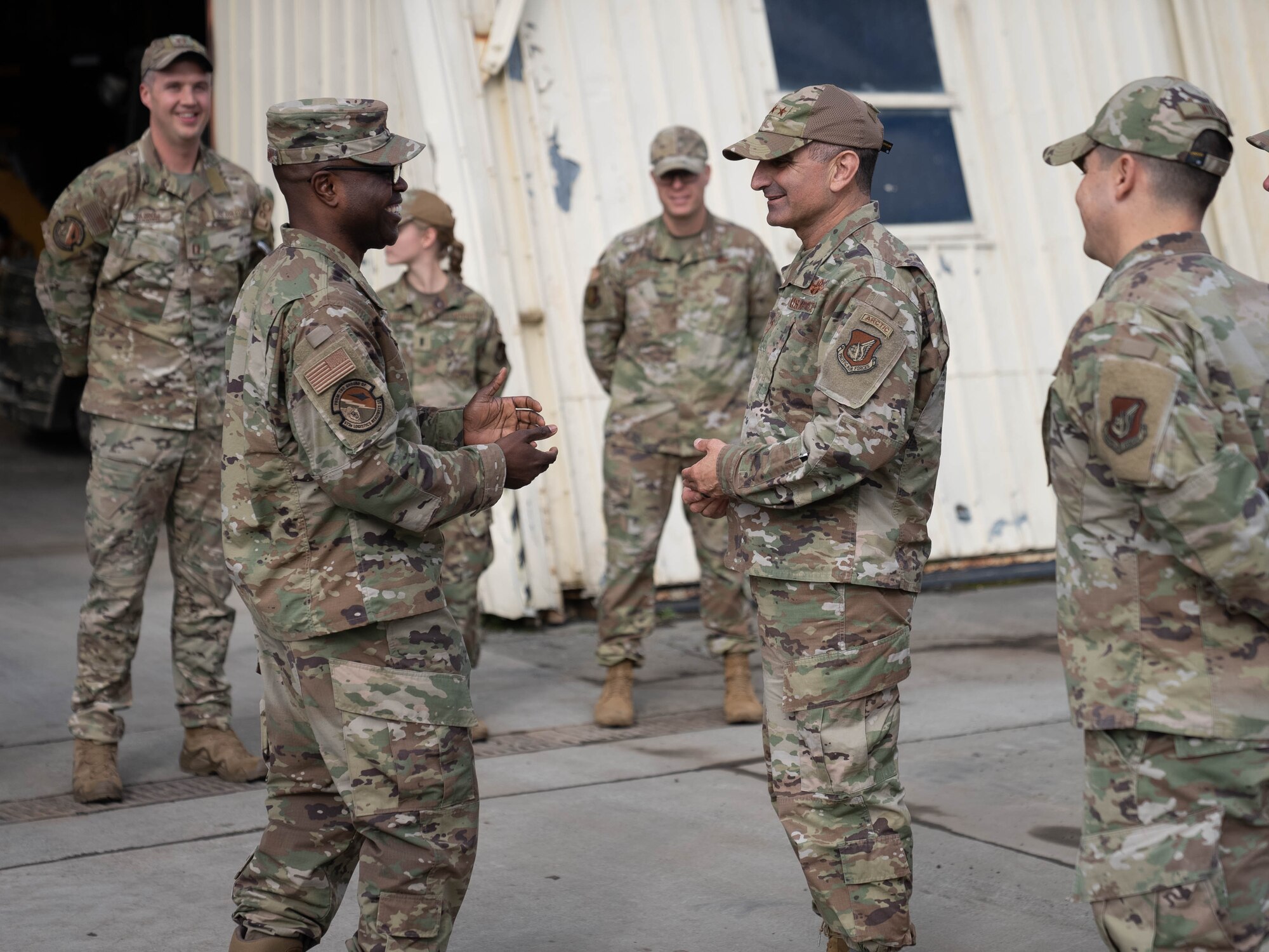 A photo of two military members greeting each other.