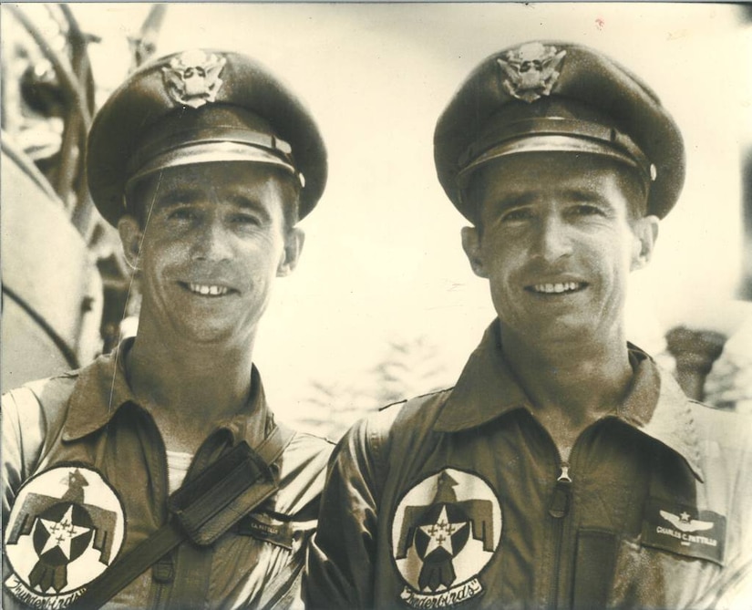 Twin pilots smile for a photo.