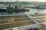 YOKOSUKA, Japan (Sept. 12, 2022) Sailors man the rails aboard the U.S. Navy’s only forward-deployed aircraft carrier, USS Ronald Reagan (CVN 76), as the ship departs Commander, Fleet Activities Yokosuka, Sept. 12. Ronald Reagan, the flagship of Carrier Strike Group 5, provides a combat-ready force that protects and defends the United States, and supports alliances, partnerships and collective maritime interests in the Indo-Pacific region. (U.S. Navy photo by Mass Communication Specialist Seaman Natasha ChevalierLosada)