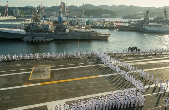 YOKOSUKA, Japan (Sept. 12, 2022) Sailors man the rails aboard the U.S. Navy’s only forward-deployed aircraft carrier, USS Ronald Reagan (CVN 76), as the ship departs Commander, Fleet Activities Yokosuka, Sept. 12. Ronald Reagan, the flagship of Carrier Strike Group 5, provides a combat-ready force that protects and defends the United States, and supports alliances, partnerships and collective maritime interests in the Indo-Pacific region. (U.S. Navy photo by Mass Communication Specialist Seaman Natasha ChevalierLosada)
