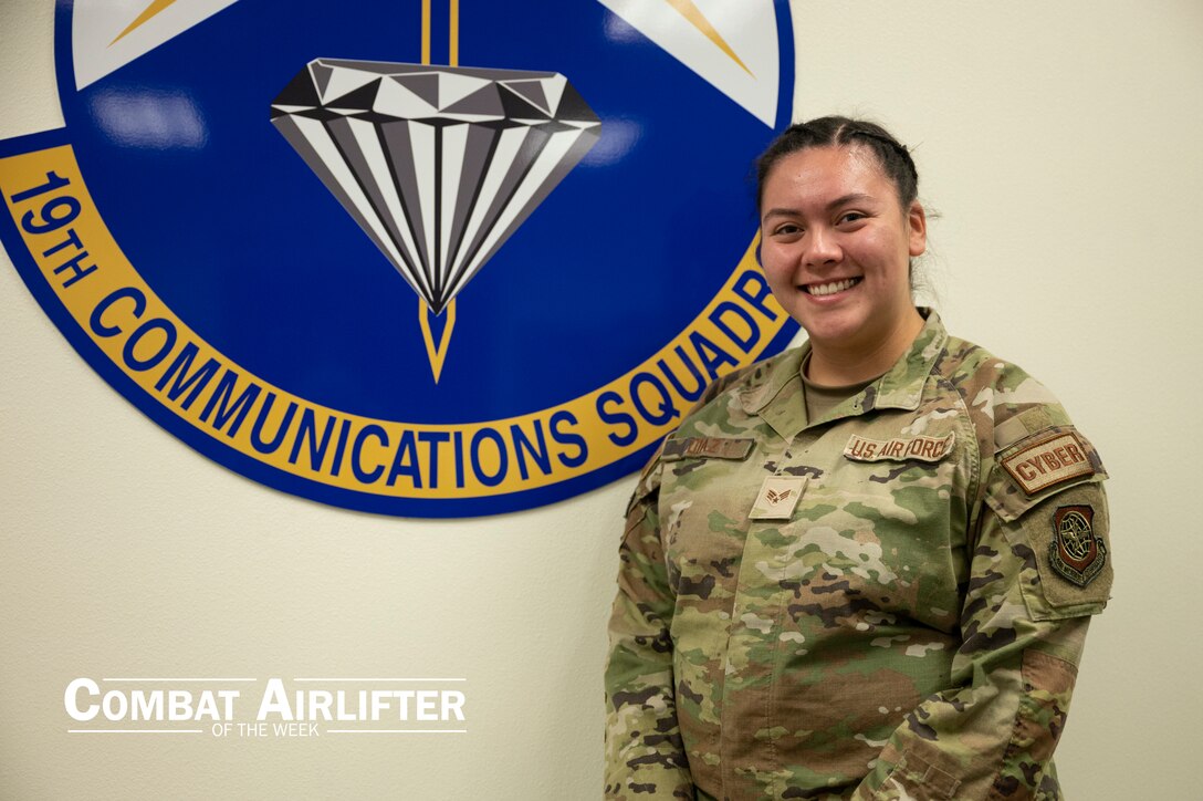 A woman in uniform poses for a photo