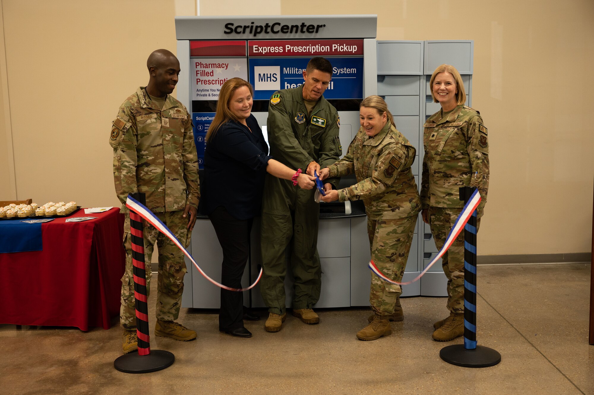 Second Bomb Wing and 2nd Medical Group leadership cut the ribbon at the ScriptCenter kiosk during a ceremony at Barksdale Air Force Base, Louisiana, Sept. 13, 2022. The ScriptCenter kiosk offers an alternative to the drive-through pharmacy for patients to pick up prescriptions. (U.S. Air Force photo by Senior Airman Chase Sullivan)