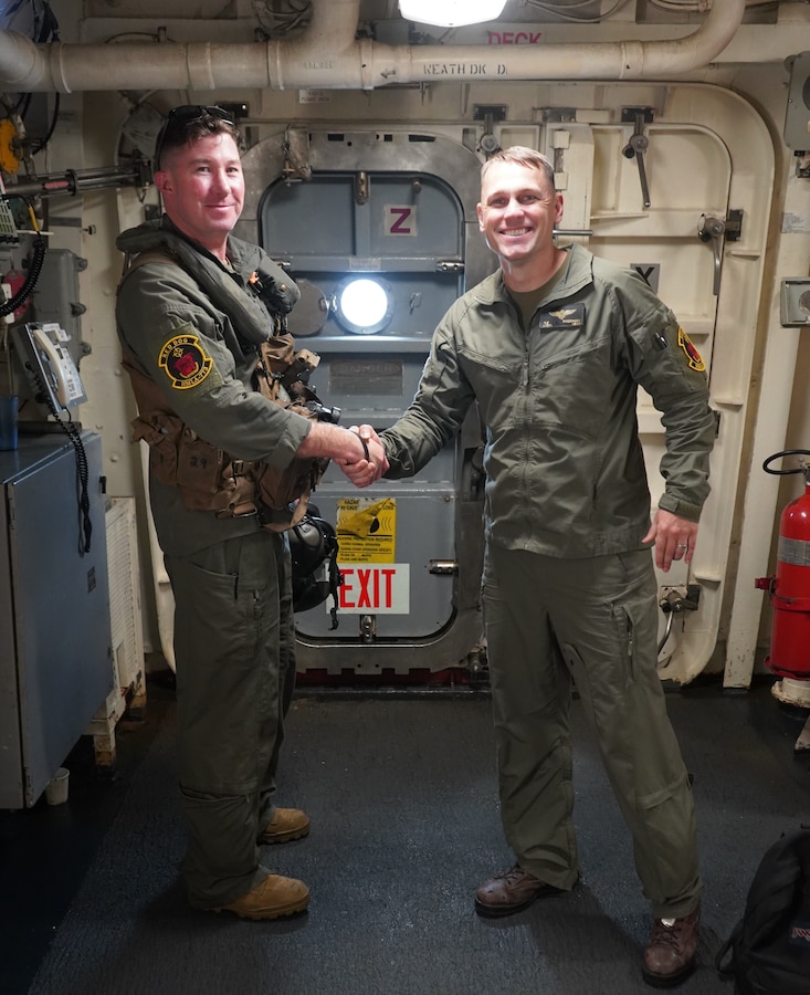 U.S. Marine Corps Lt. Col. William Woodward, right, commanding officer of Marine Light Attack Helicopter Squadron (HMLA) 773, Marine Air Group 41, 4th Marine Aircraft Wing, in support of Special Marine Air-Ground Task Forces UNITAS LXIII, shakes the hand of, and congratulates, U.S. Marine Corps Lt. Col. John Bopp, left, on his final flight in a U.S. Marine Corps UH-1Y Venom following aerial support operations throughout exercise UNITAS LXIII, Sept. 17th, 2022. UNITAS, which is Latin for “unity,” was conceived in 1959 and has taken place annually since first conducted in 1960. This year marks the 63rd iteration of the world’s longest-running annual multinational maritime exercise. Additionally, this year Brazil will celebrate its bicentennial, a historical milestone commemorating 200 years of the country’s independence. (U.S. Marine Corps photo by Maj. Jeremy Wheeler)