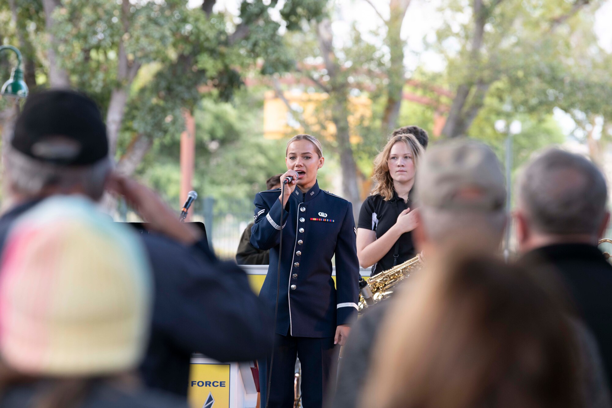 Airman First Class Natalie Angst, United States Air Force Band of the Golden West vocalist, sings the national anthem during a POW/MIA tribute ceremony, Sept. 18, 2022, in Vacaville, California.  National POW/MIA Recognition Day is observed on the third Friday in September to honor those who were prisoners of war and those who are still missing in action.