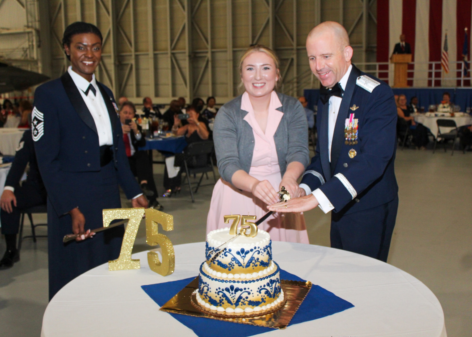 Brig. Gen. Matthew Higer, 412th Test Wing Commander, and Senior Airman Allyson Biamonte, 412th Comptroller Squadron, and youngest Airman in attendance, cuts the cake during the 2022 Department of the Air Force Ball at Edwards Air Force Base, California, Sept. 16. (Air Force photo by Laura Maples)