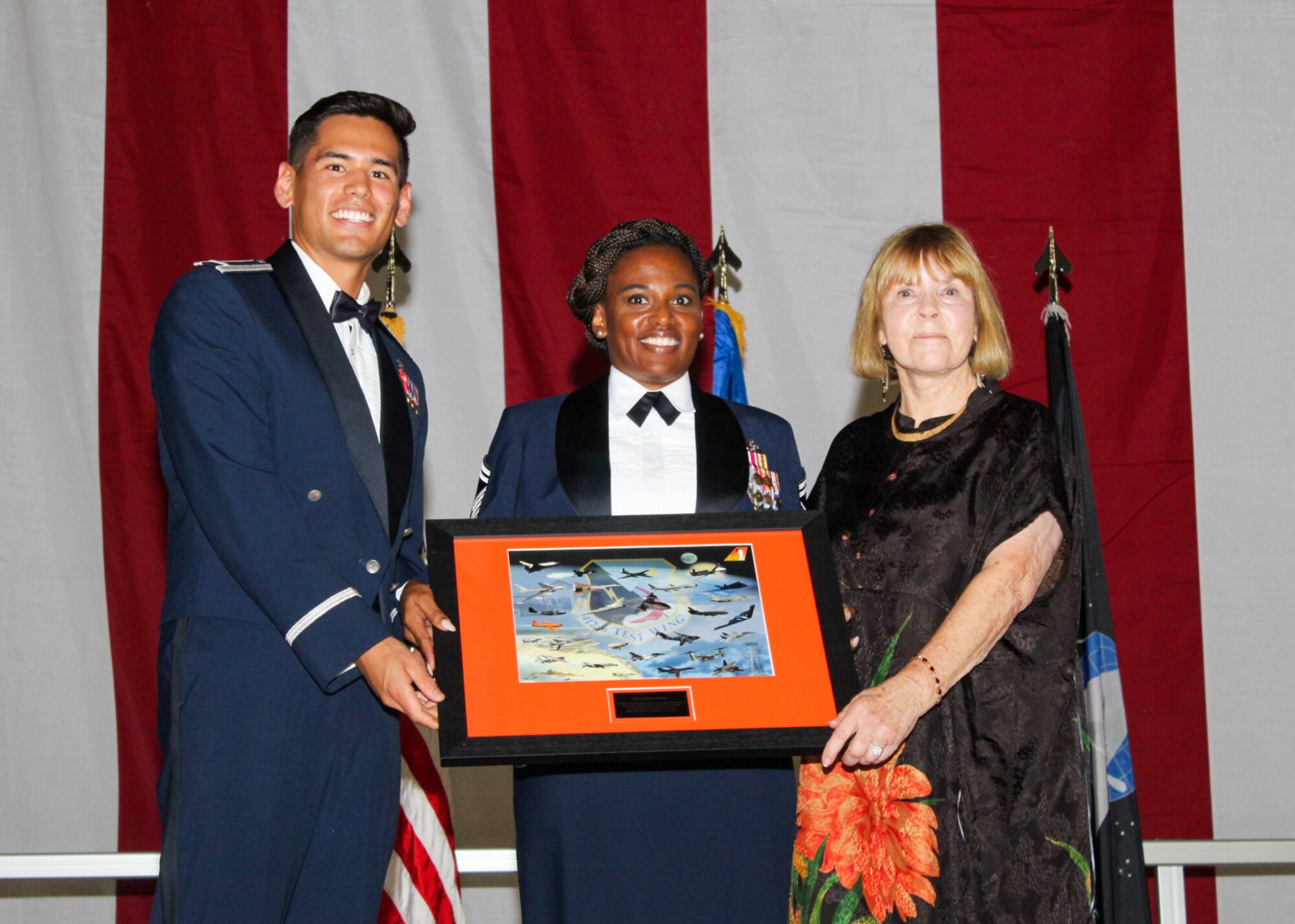 The 2022 Department of the Air Force Ball committee members presents a gift of appreciation to Barbara Schultz, the keynote speaker at the DAF Ball, at Edwards Air Force Base, California, Sept. 16. (Air Force photo by Laura Maples)