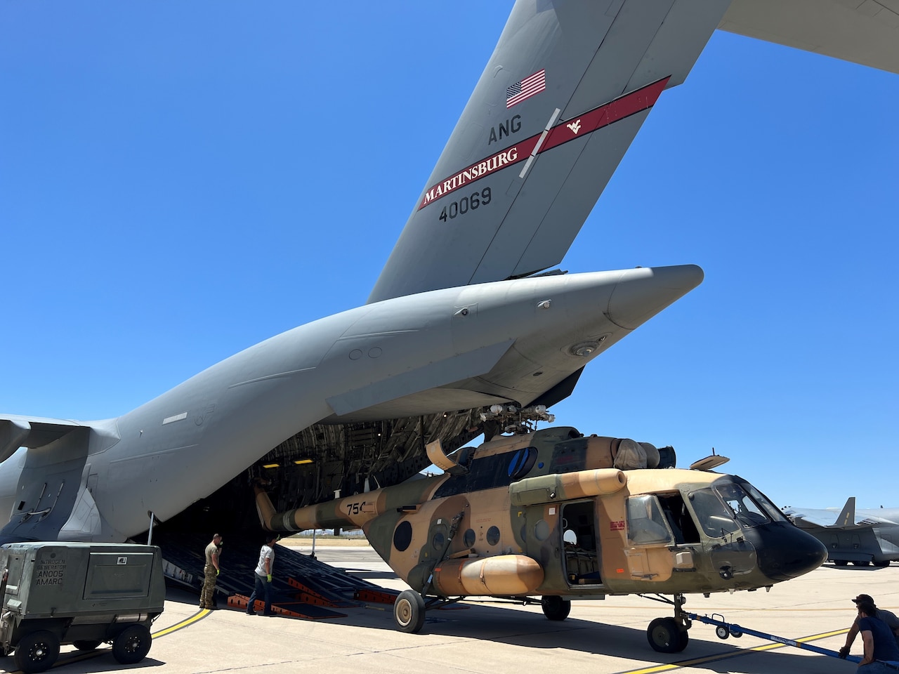 A helicopter is fitted into the back of a C-17.