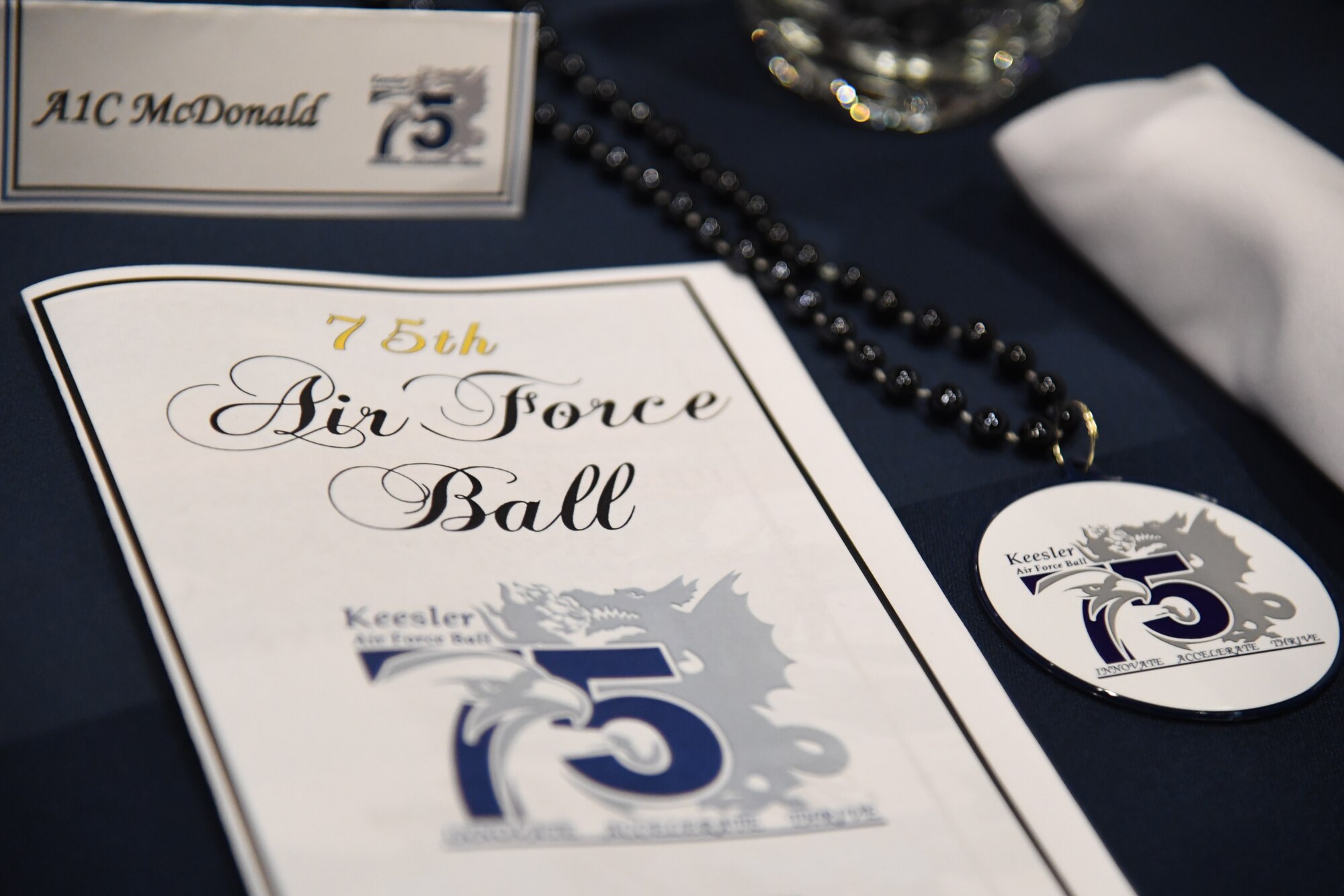 An event program is displayed during the Keesler Air Force Ball inside the IP Casino Resort Spa at Biloxi, Mississippi, Sept. 17, 2022. The event, which celebrated the Air Force's 75th birthday, also included a cake cutting ceremony. (U.S. Air Force photo by Kemberly Groue)