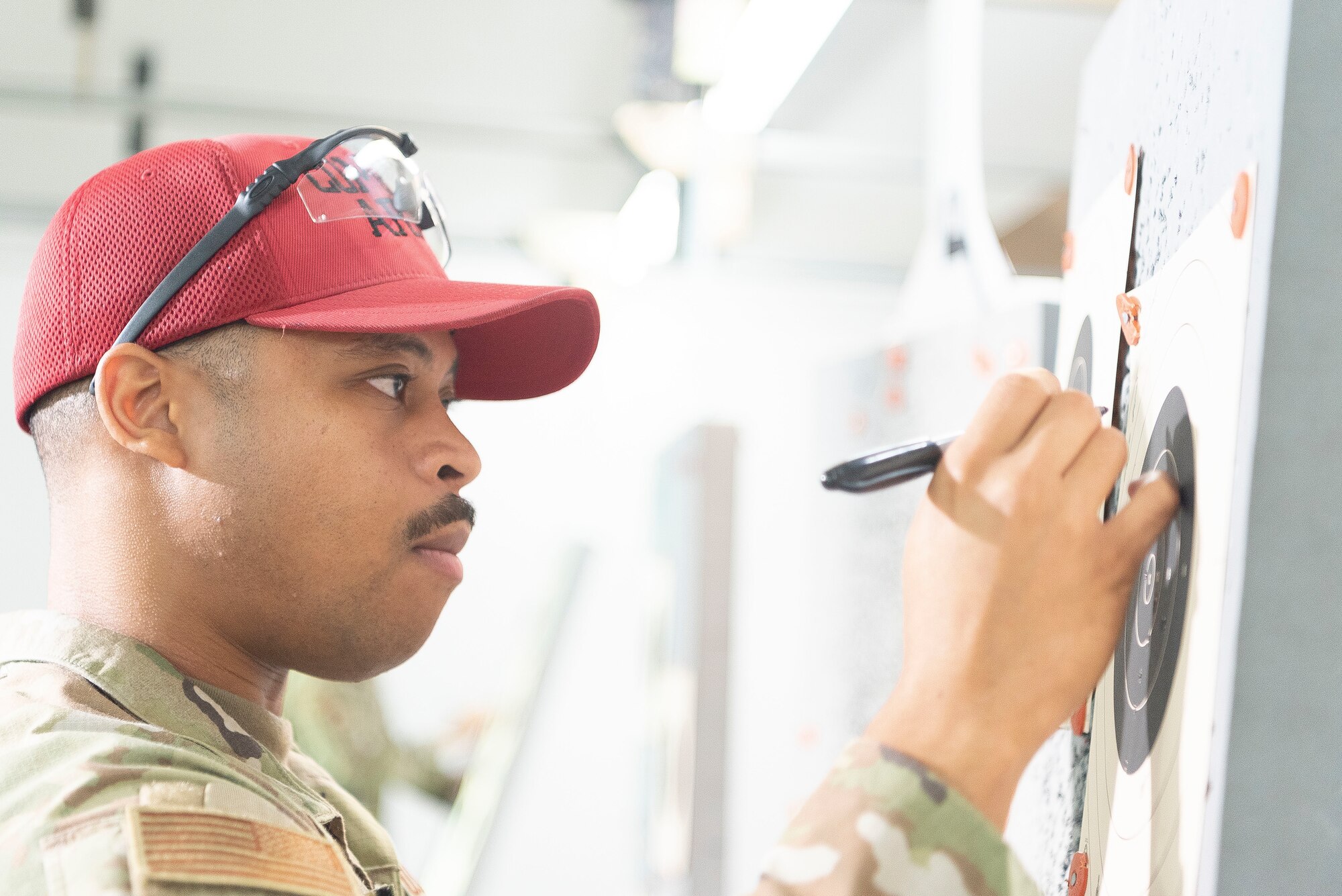 Tech. Sgt. Nathaniel Green, 374th Security Forces Squadron Combat Arms NCO in charge, scores a target during the Excellence in Competition Sept. 15, 2022, at Yokota Air Base, Japan.