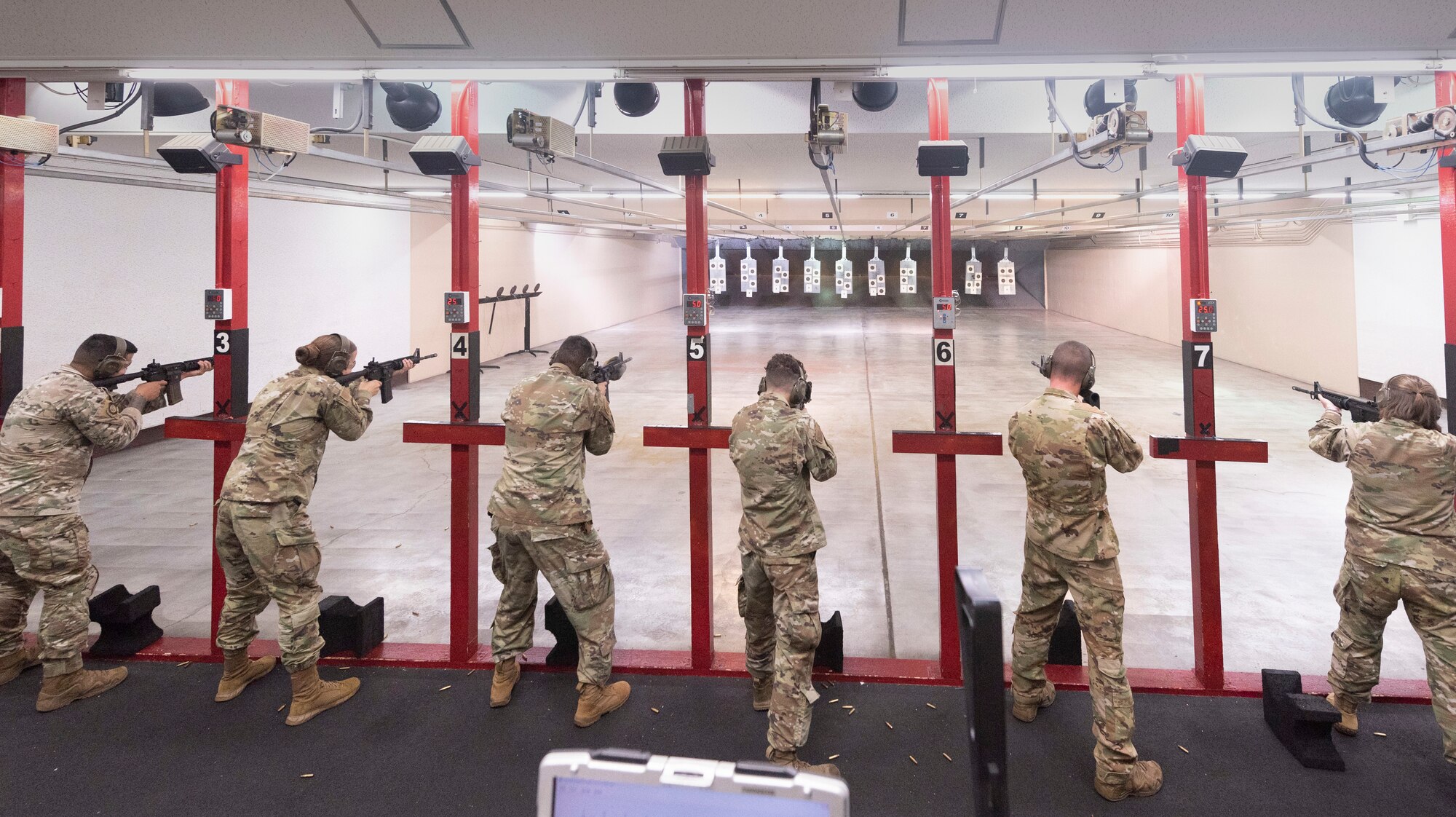 Participants in the Excellence in Competition fire the M4 carbine at Yokota Air Base, Japan, Sept. 15, 2022.