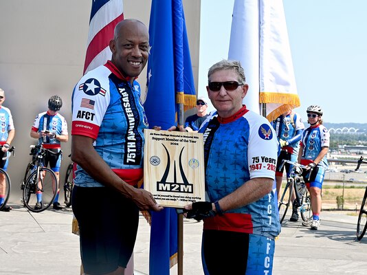 two cyclists pose for a photo