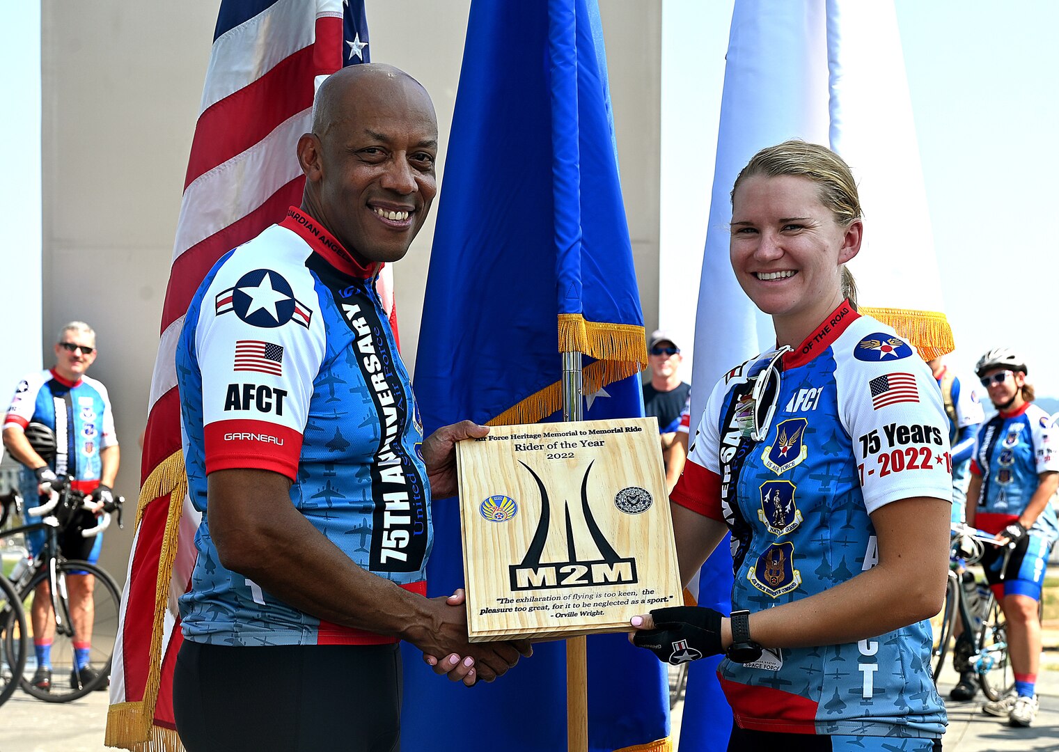 two cyclists pose for a photo