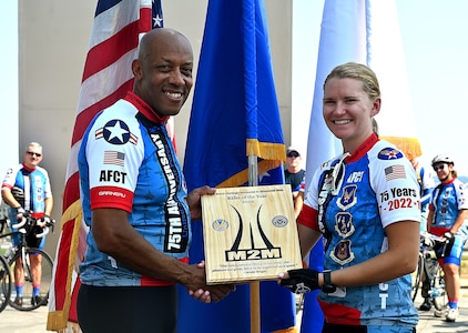 two cyclists pose for a photo