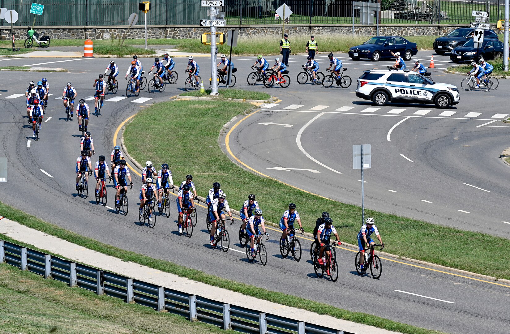 group of cyclists parade up a hill