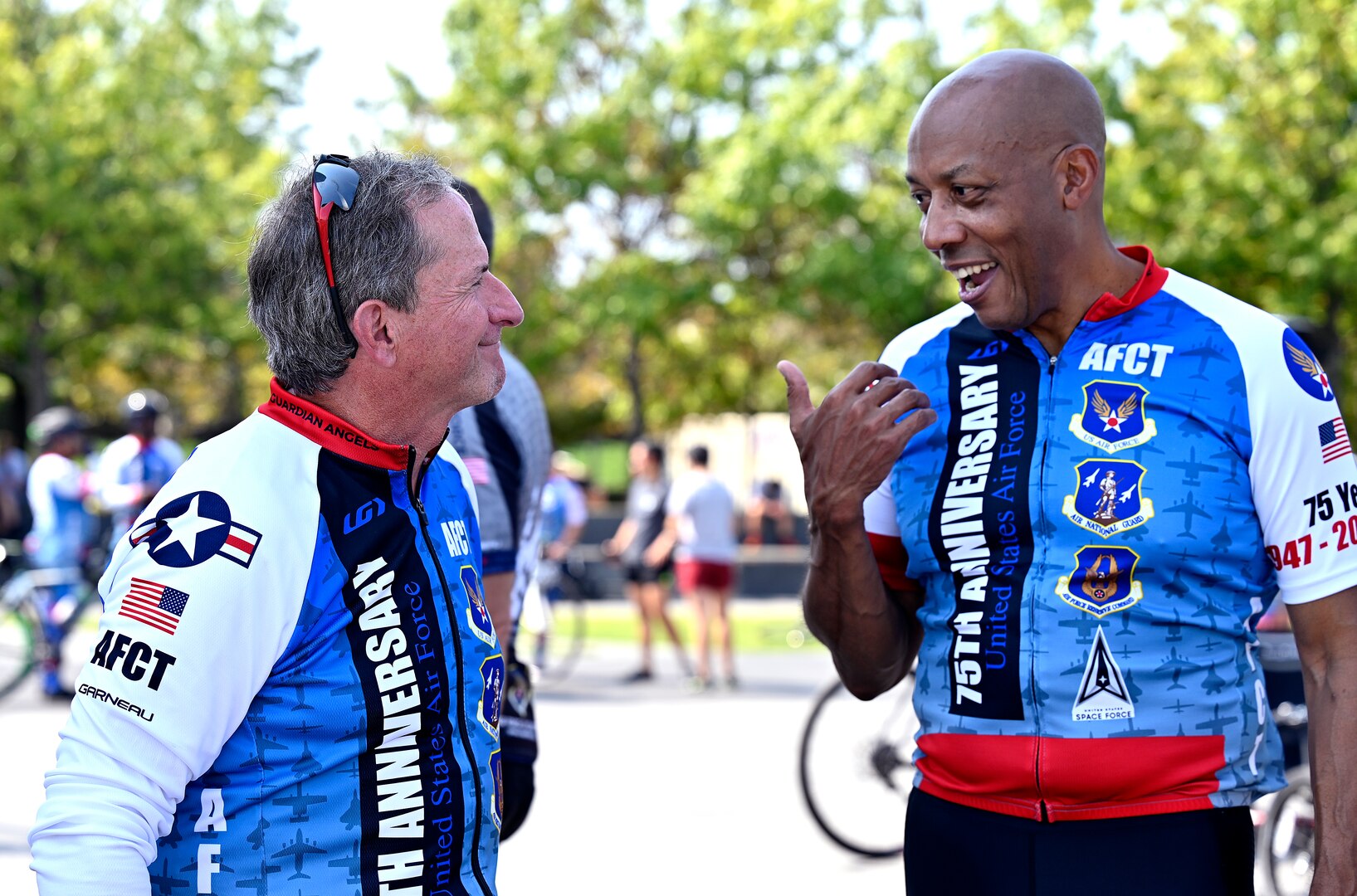 two male cyclists speak to one another