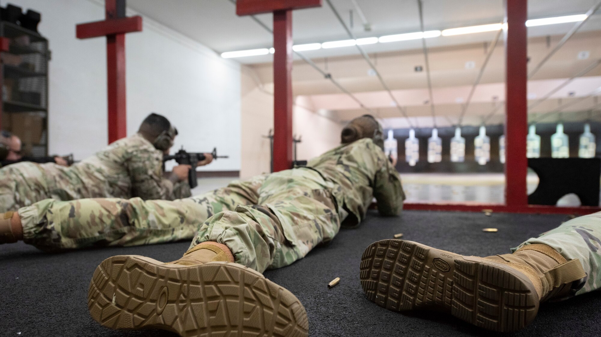 Senior Airman Cassidy Holiday, 374th Security Forces Squadron unit scheduler and augmentee program manager, center, fires in the prone position during the Excellence in Competition Sept. 15, 2022, at Yokota Air Base, Japan.