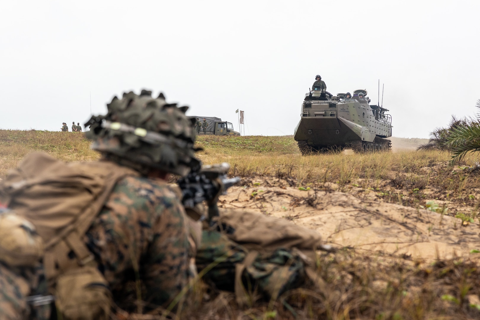 U.S. Marine Corps Cpl. Eli Smith, a squad leader with Lima Company, 3rd Battalion, 25th Marine Regiment, 4th Marine Division, in support of Special Purpose Marine Air-Ground Task Force UNITAS LXIII provides cover for a Brazilian amphibious assault vehicle conducting an amphibious assault training event during exercise UNITAS LXIII in Itaoca, Brazil, Sept. 16, 2022. A landing craft, utility was used to move Brazilian, United States, and Uruguayan marines to shore from the amphibious transport dock ship USS Mesa Verde (LPD 19), where they secured a beachhead. UNITAS is the world’s longest-running annual multinational maritime exercise that focuses on enhancing interoperability among multiple nations and joint forces during littoral and amphibious operations in order to build on existing regional partnerships and create new enduring relationships that promote peace, stability, and prosperity in the U.S. Southern Command’s area of responsibility. Smith is a native of Toledo, Ohio. (U.S. Marine Corps photo by Lance Cpl. David Intriago)