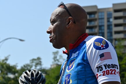 male speaks to group of cyclists