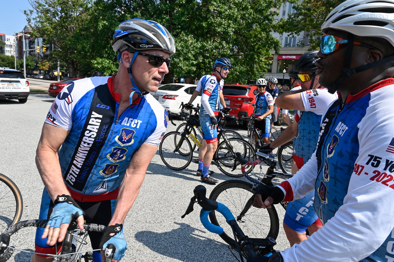 two male cyclists speak to each other