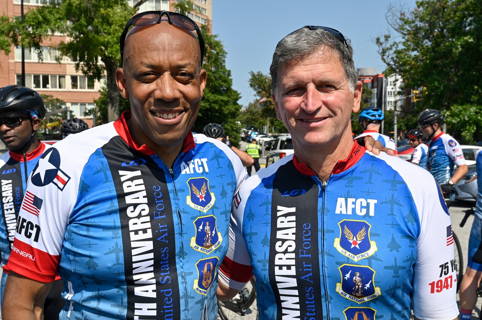 two male officers pose for a photo in AFCT cycling kits