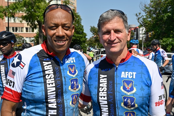 two male officers pose for a photo in AFCT cycling kits