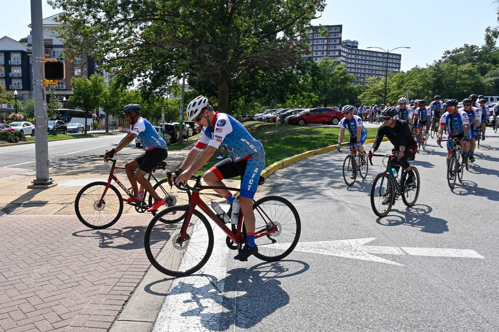 male cyclists lead a group of cyclists