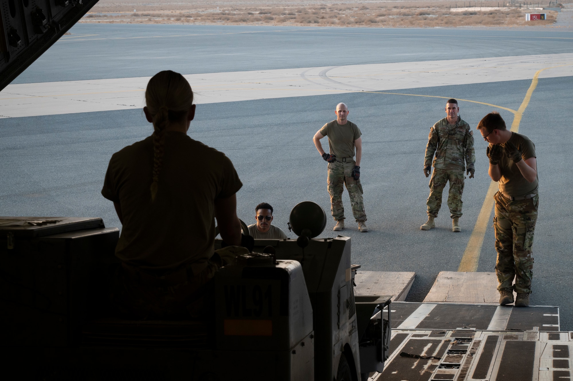 U.S. Air Force Airman 1st Class Josephine Bock, 386th Expeditionary Force Support Squadron shift supervisor, operates a aircraft bomb loader to unload it from a C-17 Globemaster III during Operation Agile Spartan III at an undisclosed location, September 7, 2022.  Airmen from multiple squadrons received training on how to operate forklifts, aircraft bomb loaders, and other skills on how to download an aircraft as quick as possible. (U.S. Air Force photo by Staff Sgt. Dalton Williams)