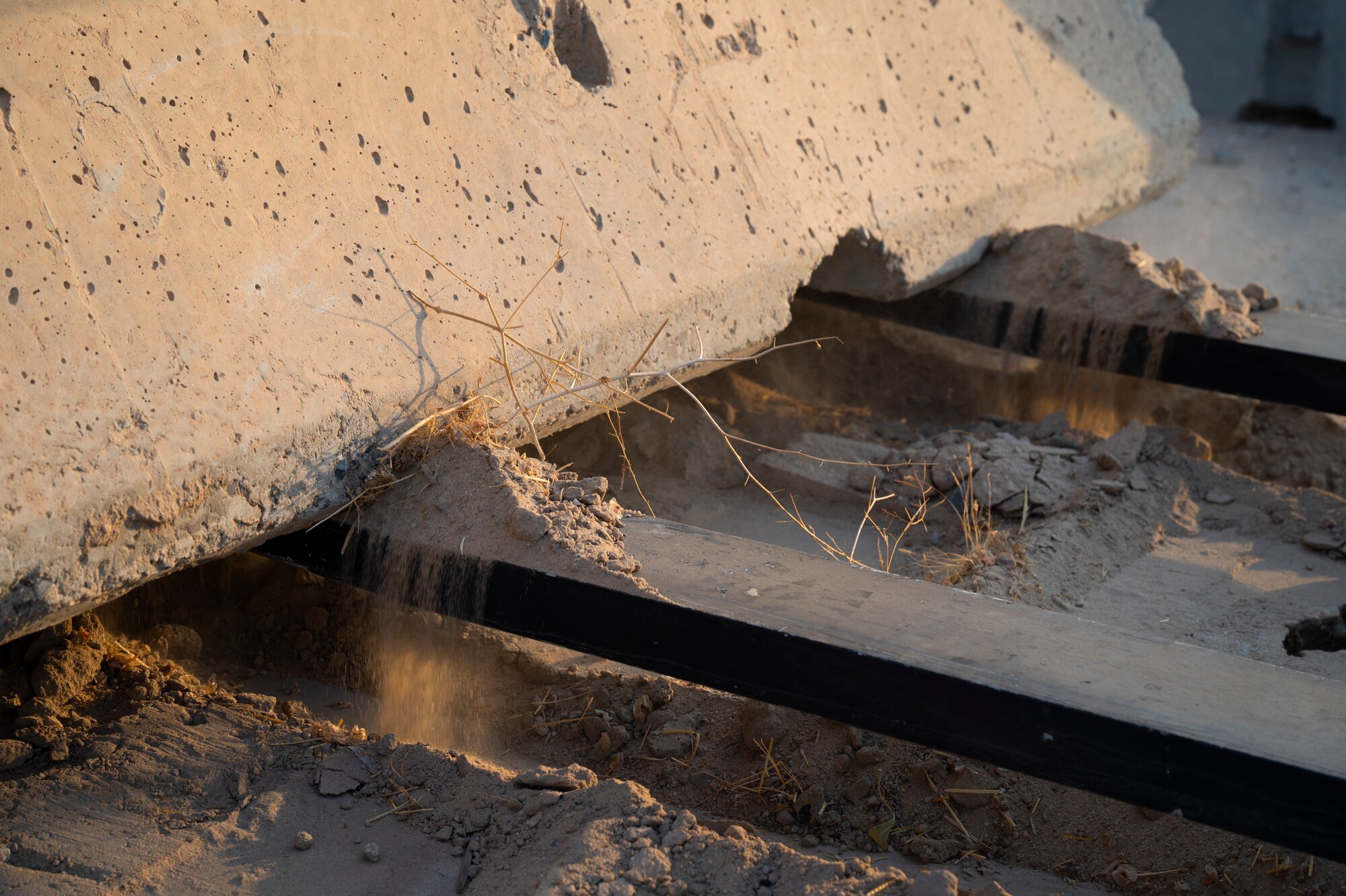 U.S. Air Force Staff Sgt. Charles Otta, 386th Expeditionary Civil Engineer Squadron pavement and equipment supervisor, picks up a security barrier with a telehandler during Operation Agile Spartan III at an undisclosed location, September 10, 2022. Airmen from the 386th ECES working to move barriers and build an entry control point for the 386th Expeditionary Security Forces Squadron is one of many examples of squadrons from different working seamlessly alongside each other in order to accomplish the mission. (U.S. Air Force photo by Staff Sgt. Dalton Williams)