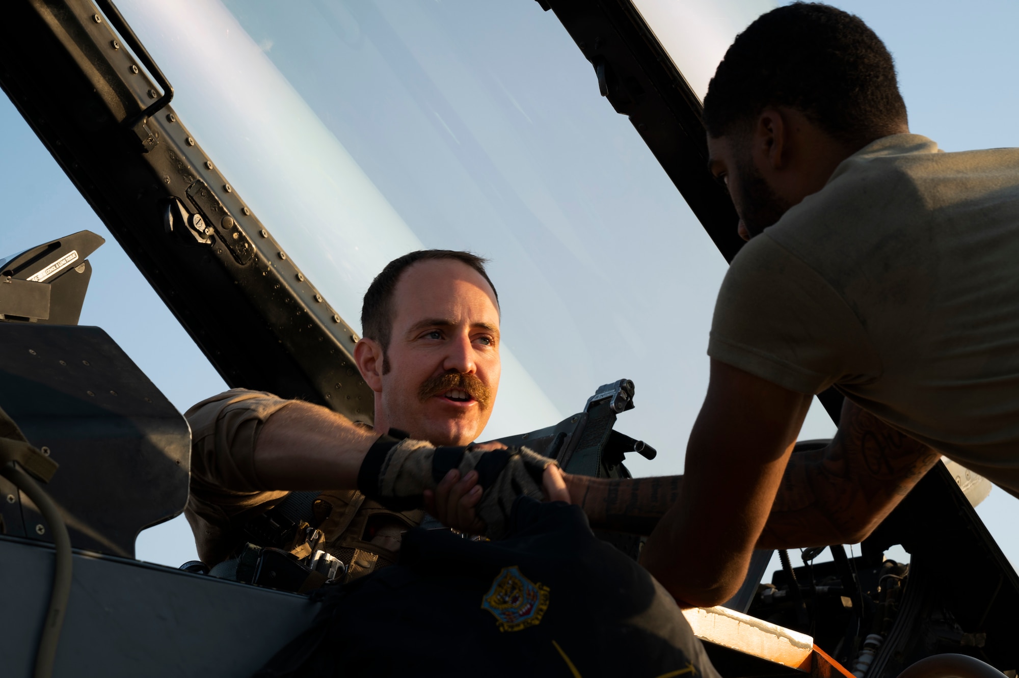 U.S. Air Force Capt. Park Lundgreen, 79th Fighter Squadron F-16CM Fighting Falcon pilot, thanks Airman 1st Class Christian Locklear, 79th Fighter Generation Squadron crew chief, prior to departure during Operation Agile Spartan III at an undisclosed location, September 12, 2022. Crew chiefs will perform end-of-runway, postflight, preflight and thru-flight operations in any condition to ensure the mission is able to be accomplished. (U.S. Air Force photo by Staff Sgt. Dalton Williams)