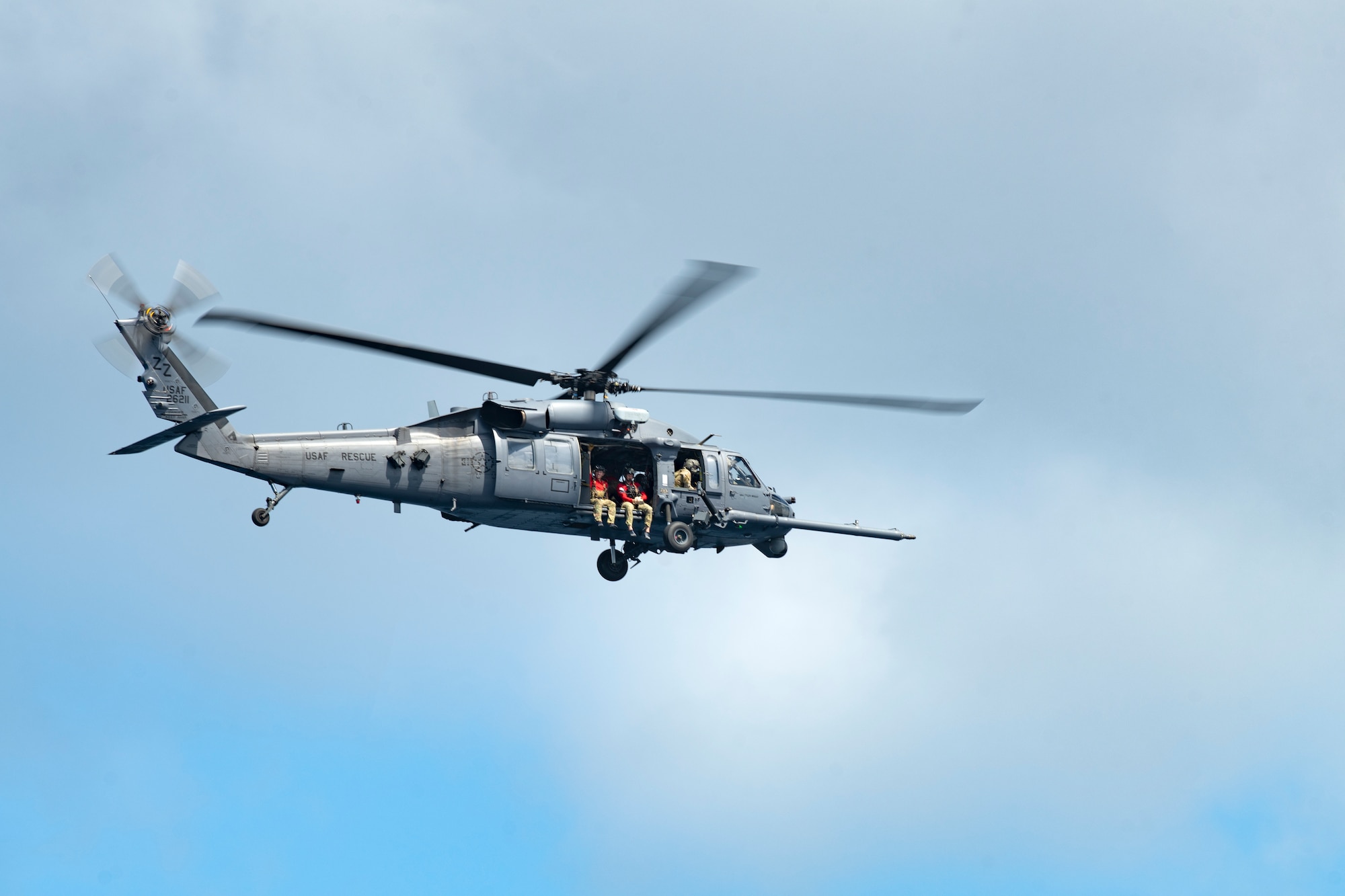 An HH-60G Pave Hawk assigned to the 33rd Rescue Squadron flies overhead during a search and rescue training exercise in the Pacific Ocean, September 13, 2022. Pararescumen assigned to the 31st RQS were on board to execute training on alternate insertion and extraction methods. (U.S. Air Force photo by Senior Airman Jessi Roth)