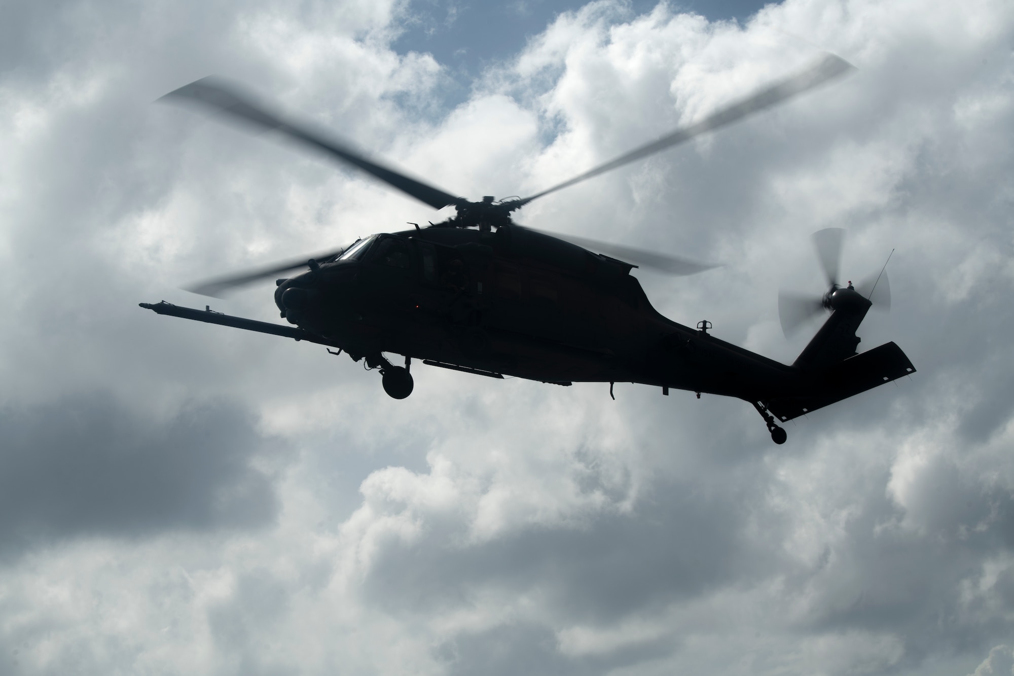 An HH-60G Pave Hawk assigned to the 33rd Rescue Squadron hovers overhead during an amphibious search and rescue training in the Pacific Ocean, Sept. 13, 2022. For humanitarian operations, the Pave Hawk can perform a multitude of roles including civil search and rescue, medical evacuation and disaster response. (U.S. Air Force photo by Senior Airman Jessi Roth)
