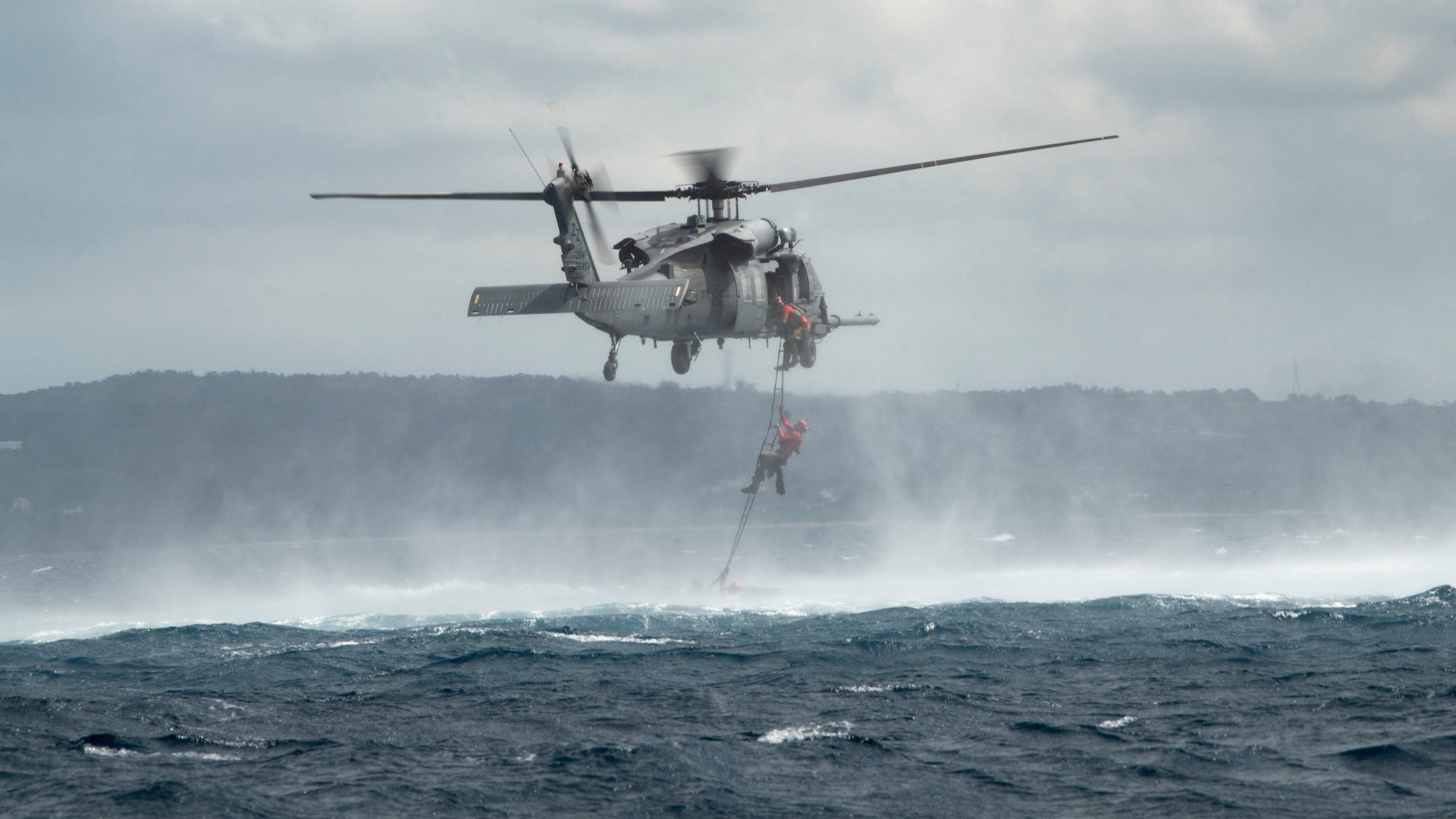 U.S. Air Force pararescuemen assigned to the 31st Rescue Squadron board an HH-60G Pave Hawk after completing an amphibious search and rescue training in the Pacific Ocean, Sept. 13, 2022. After reaching the extraction point, PJ’s were lifted from the water via hoist back into the aircraft. (U.S. Air Force photo by Senior Airman Jessi Roth)