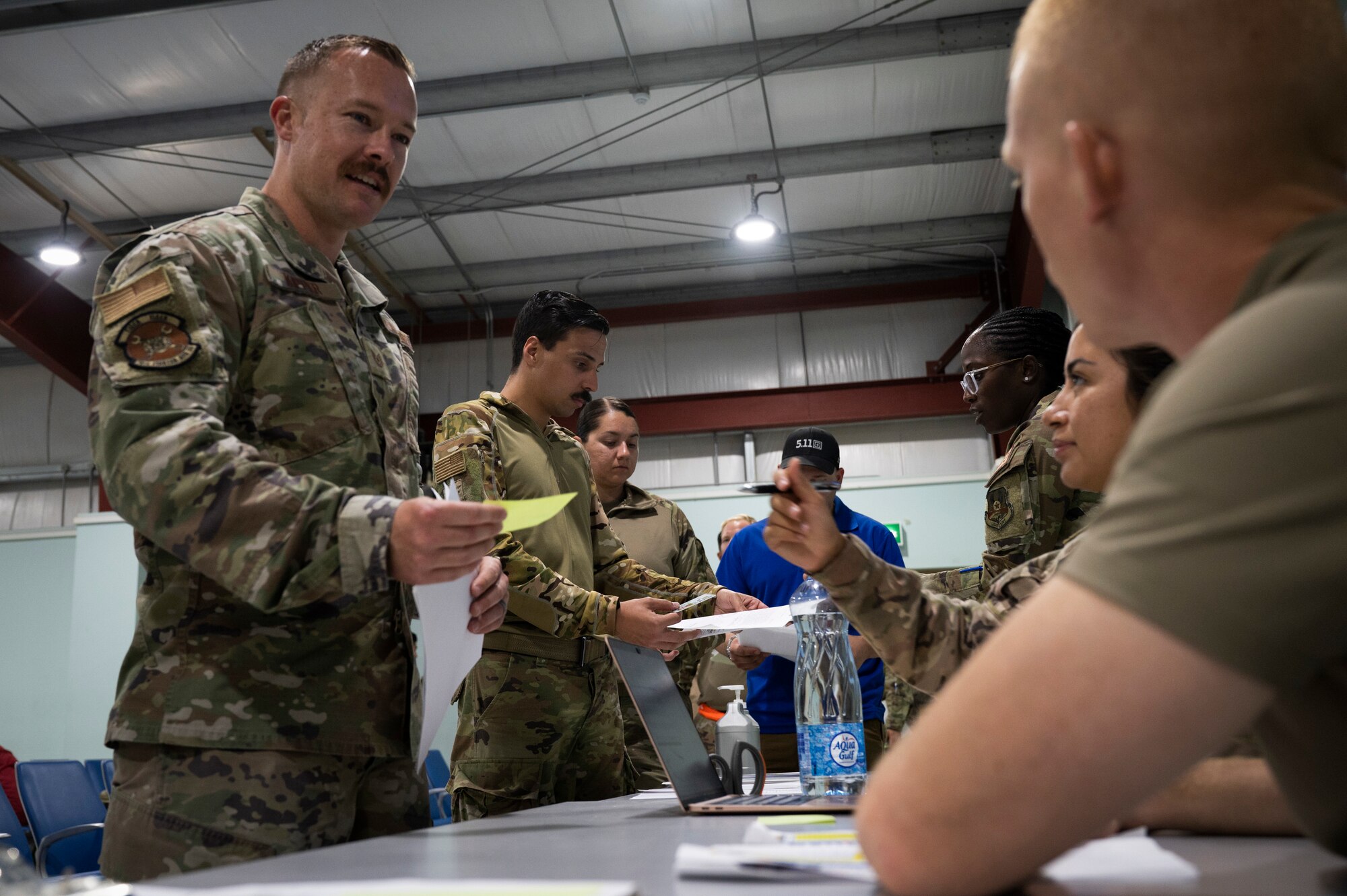 U.S. Air Force Tech. Sgt. Leland Lelix, 386th Expeditionary Force Support Squadron services craftsman, right, inprocesses Tech. Sgt. Adam Kipper, 79th Fighter Generation Squadron support NCOIC, during Operation Agile Spartan III at an undisclosed location, September 3, 2022. OAS III tested Ninth Air Force (Air Forces Central)’s ability to execute rapid troop and equipment movement to and from dispersed locations around the U.S. Central Command area of responsibility. Lelix worked hand-in-hand alongside his team to make sure that Airmen arriving from Prince Sultan Air Base, Kingdom of Saudi Arabia, would have vital support available to them as soon as they arrived, such as lodging areas and a dining facility. (U.S. Air Force photo by Staff Sgt. Dalton Williams)