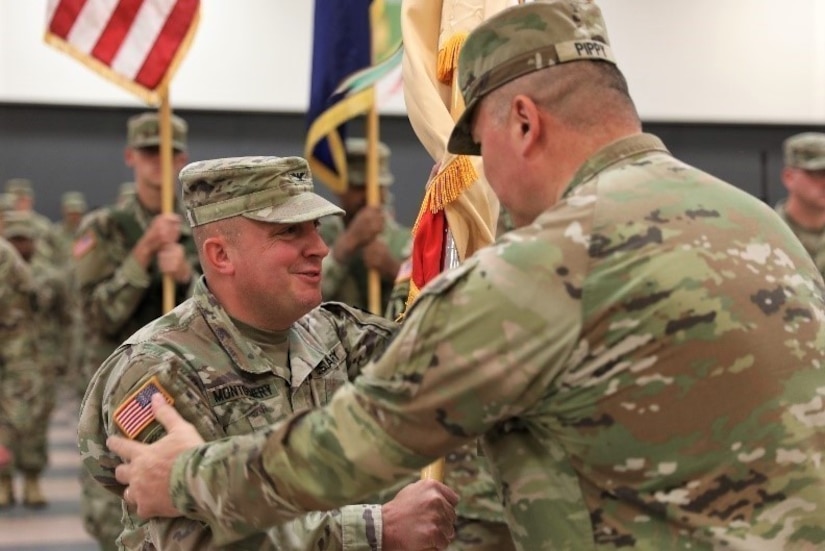 Incoming commander of the 213 Regional Support Group Col. Frank Montgomery receives the unit's colors from Brig. Gen. John Pippy, Pennsylvania National Guard land component commander, during the 213th RSG’s change of command ceremony at Fort Indiantown Gap Sept. 18, 2022.