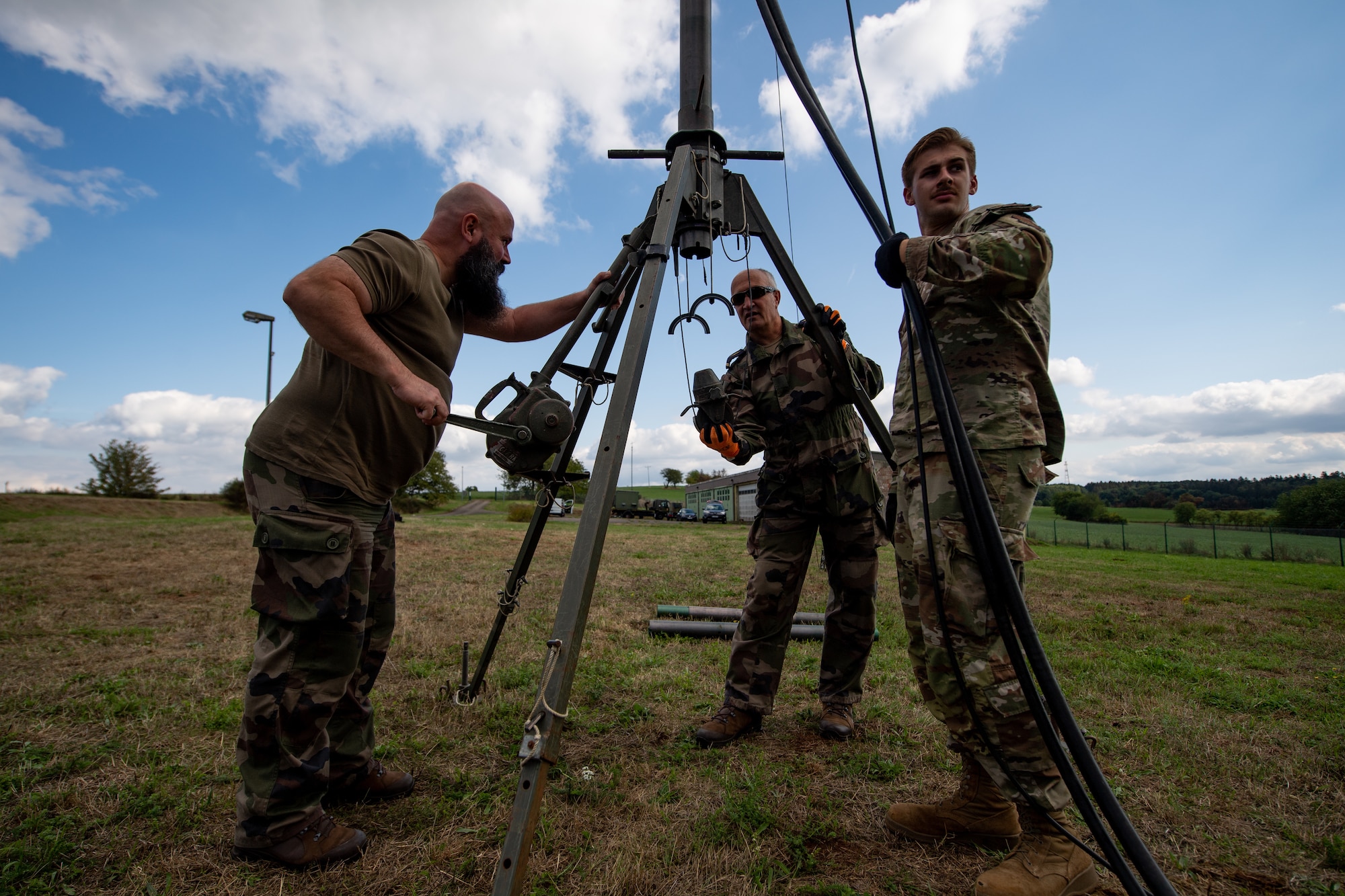 French and U.S. Service members disassemble an antenna used by the French