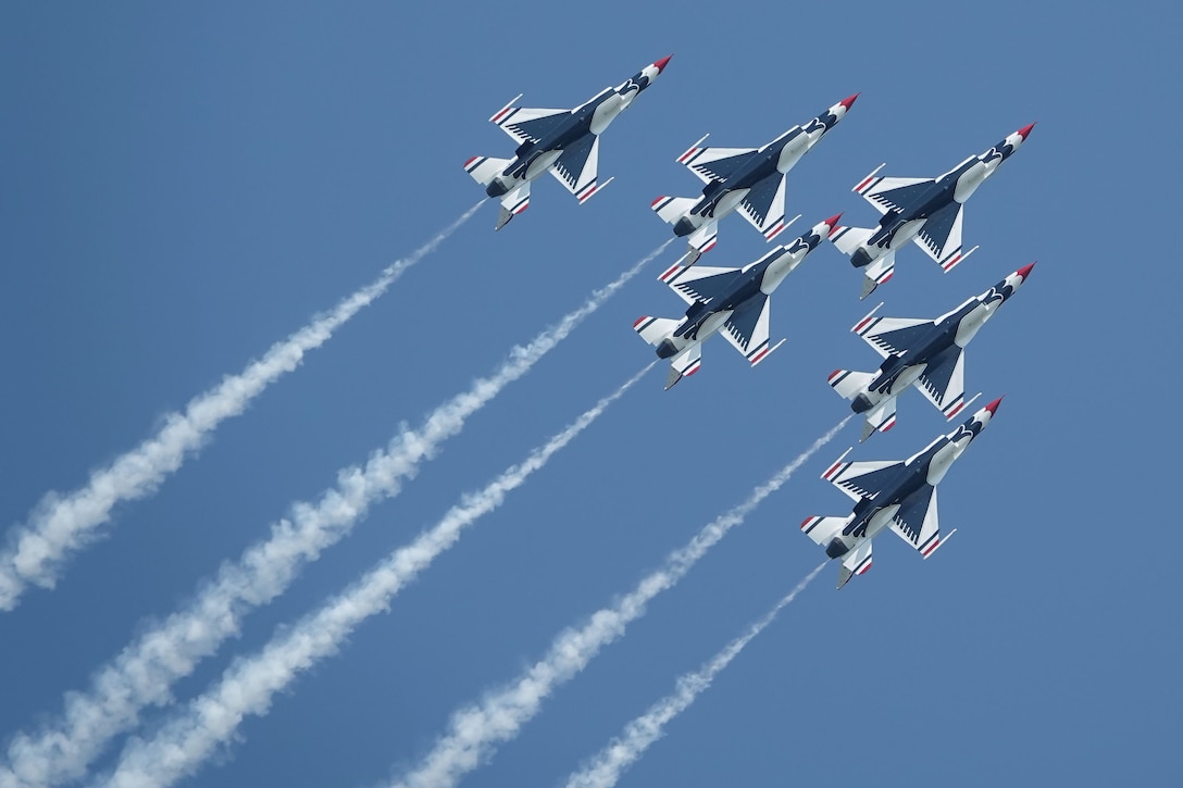 A group of fighter jets fly in formation.